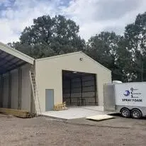 Completed metal building with MEI spray foam trailer outside