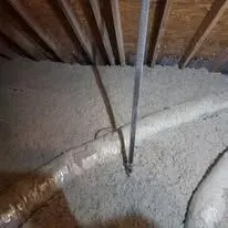 Attic insulation installed between wood ceiling joists